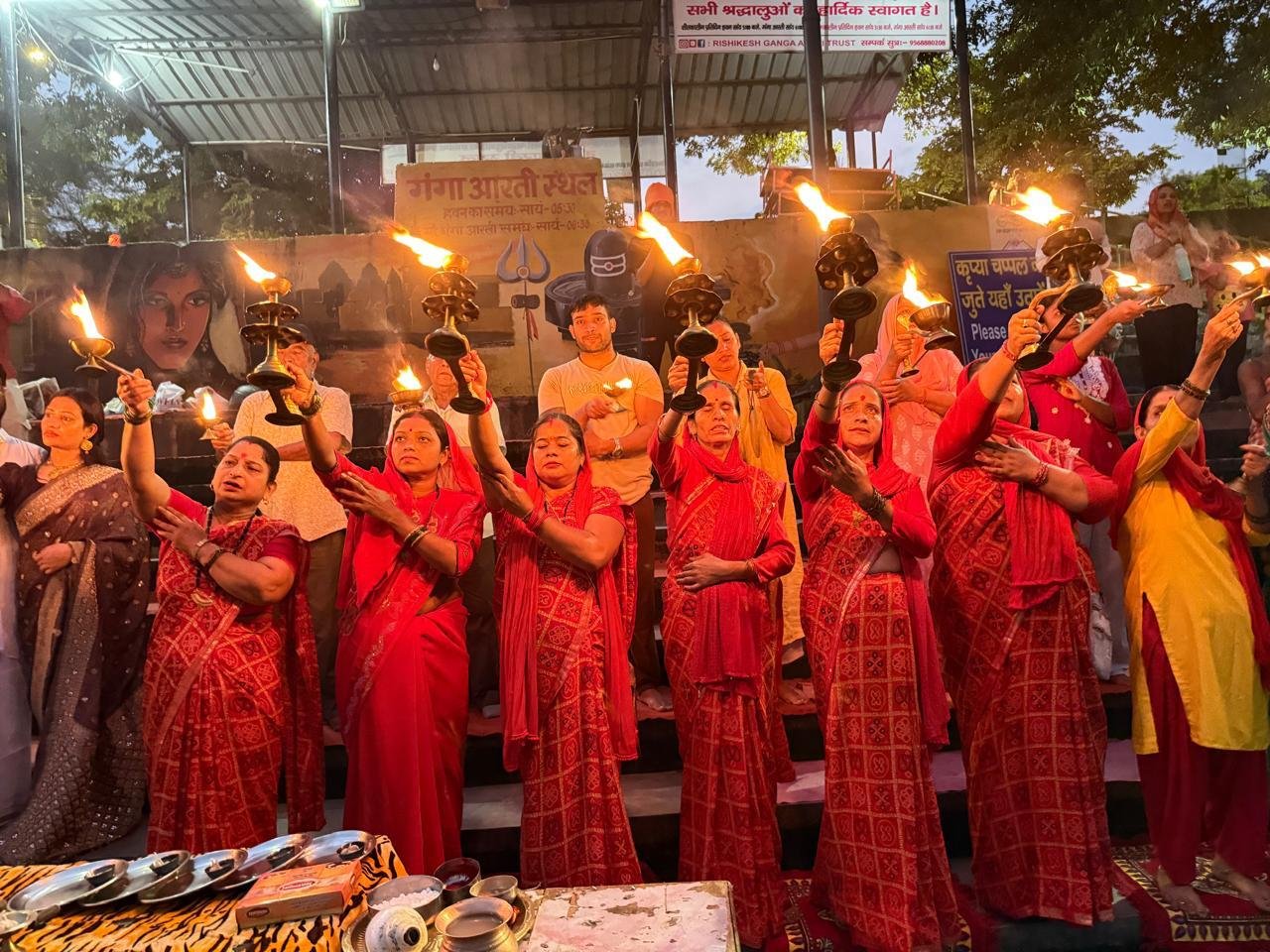 Sacred Ganga Aarti ceremony along the Ganges ghats with brass lamps and devotional atmosphere
